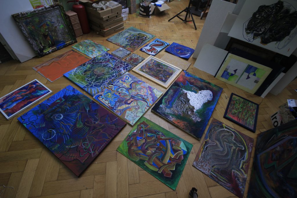 Paintings spread across the studio floor